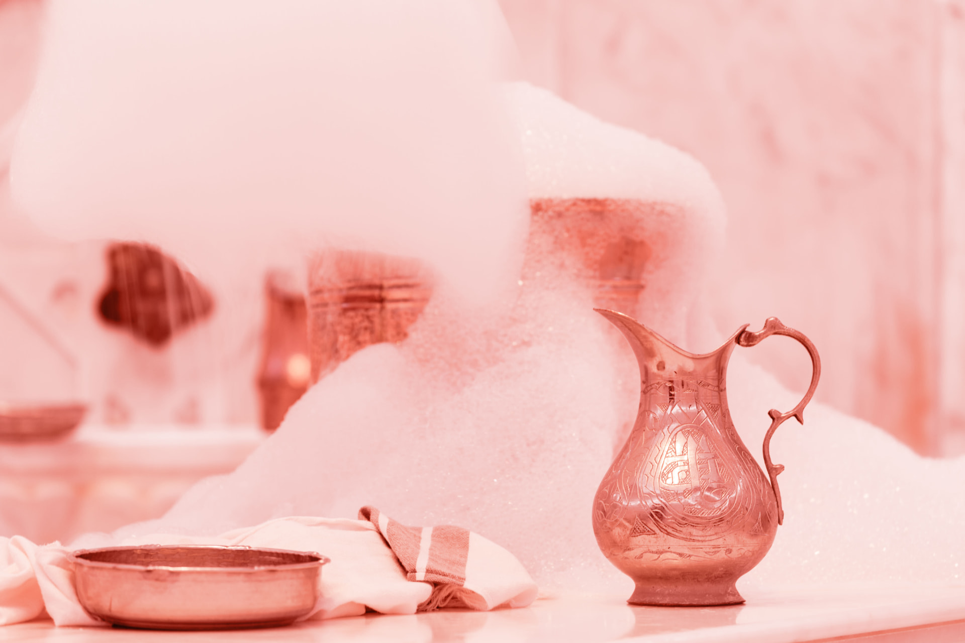 Copper hammam jug and bowl with soft rose-tinted foam