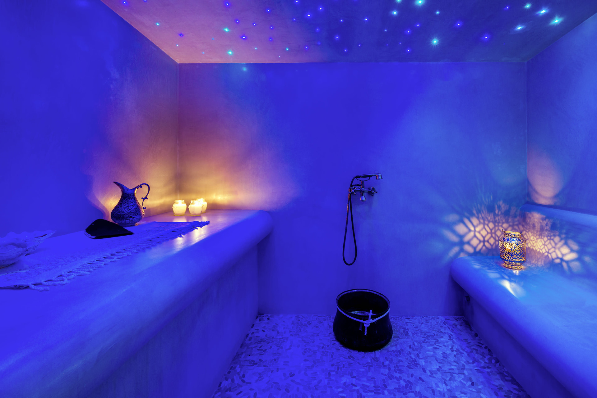 Star-lit hammam steam room with lanterns and candles